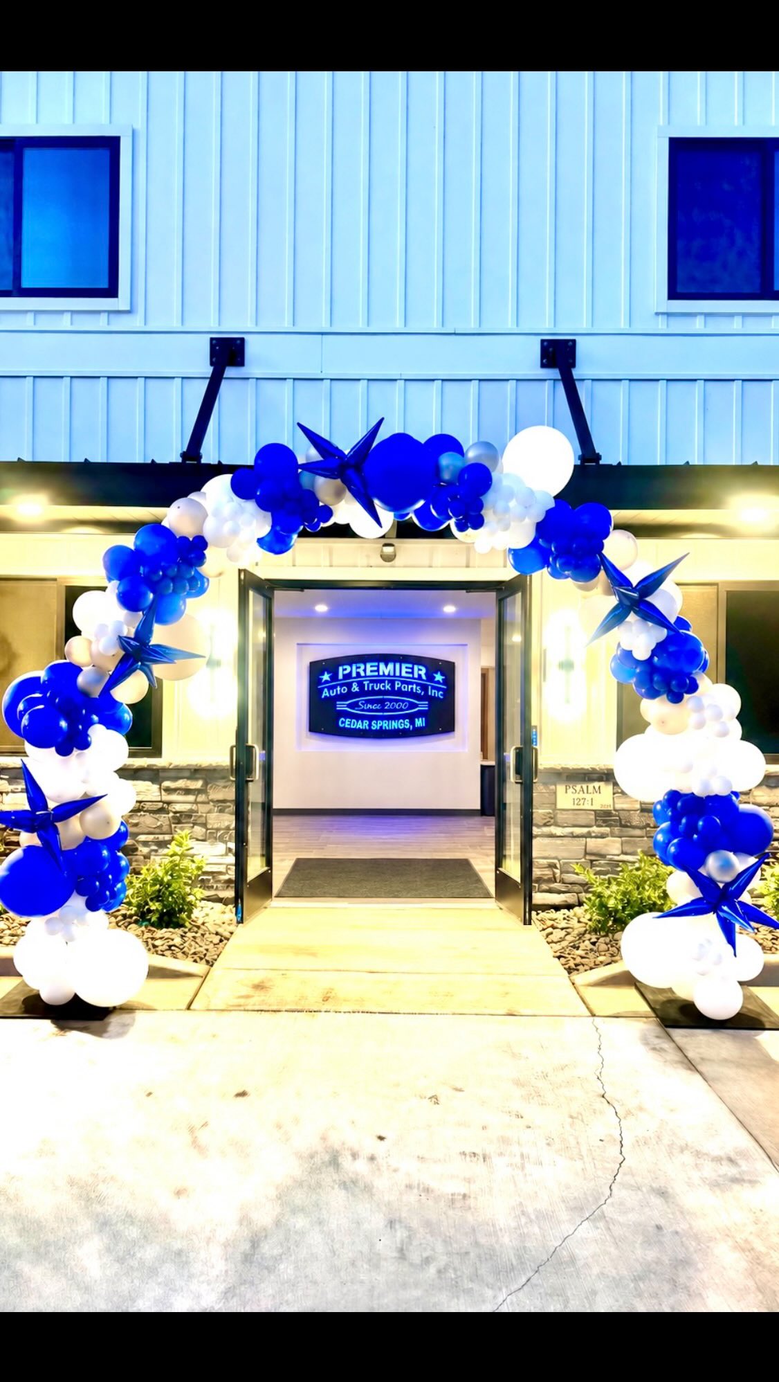 Blue, white, and silver balloon arch created for the Premier Auto grand opening