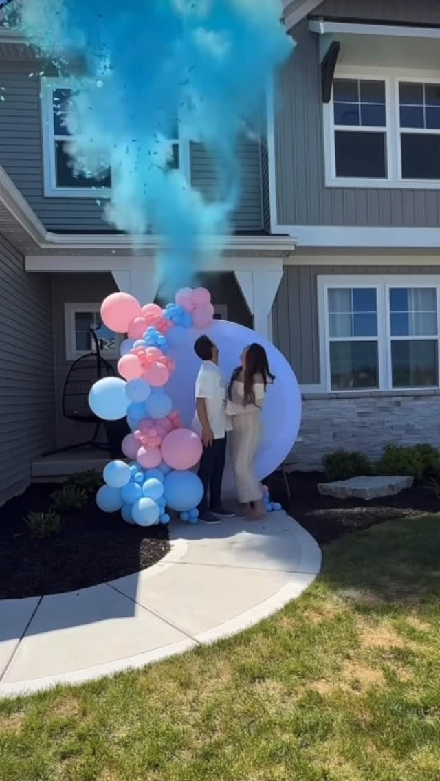 Blue gender reveal balloon backdrop for a baby boy celebration